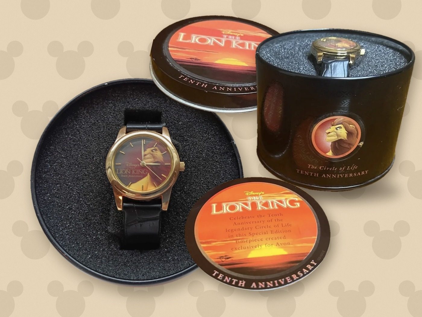 Lion King Tenth Anniversary collector set: the black tin with the watch inside, the sunset lid, the collector card, and a top view of the watch in its tin