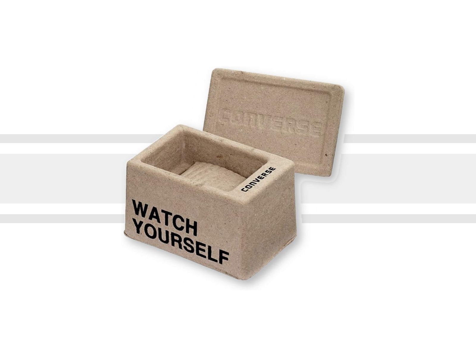 Converse watch packaging: a molded kraft-pulp box with the lid open and the words watch yourself printed on the front